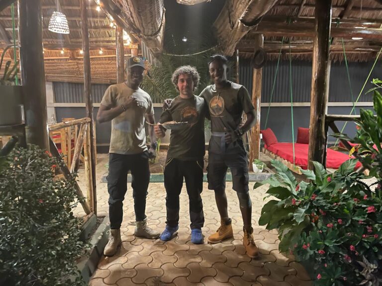 Two guides and one trekker smiling in Moshi after completing their Mount Kilimanjaro climb with Kilimanjaro Joy, preparing for the celebration.